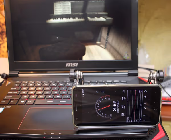 With luck a cooling pad will allow for slightly lower fan speeds which in total drops the noise level