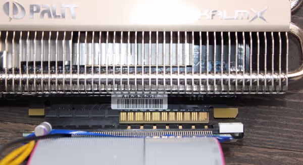 A graphics card in a x4 riser showing remaining pins not connected. The GPU will work, just at a lower throughput