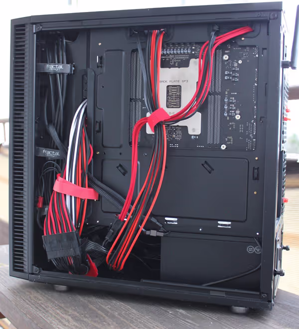 Behind the motherboard