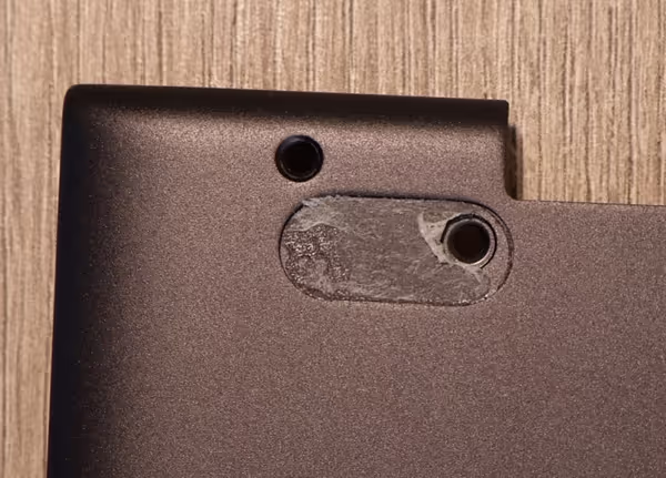 Hidden screw next to an exposed one