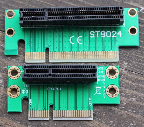 x8 and x4 PCB risers. The x8 has a closed connector and can't accept a full length card. The x4 is open at the end and can connect to a GPU