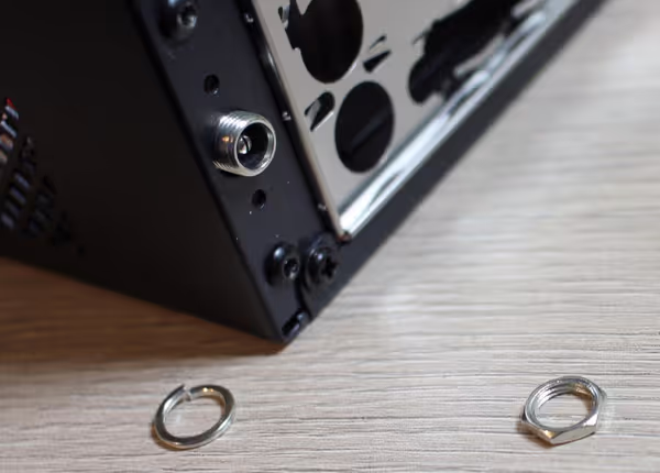 Chieftec case has a dedicated hole for the DC adapter that can be securely screwed on the back of the case